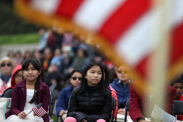 Children look on during a naturalization ceremony for kids between the ages of 6-12 at Crissy Field near the Golden Gate Bridge on August 17, 2018 in San Francisco, California.